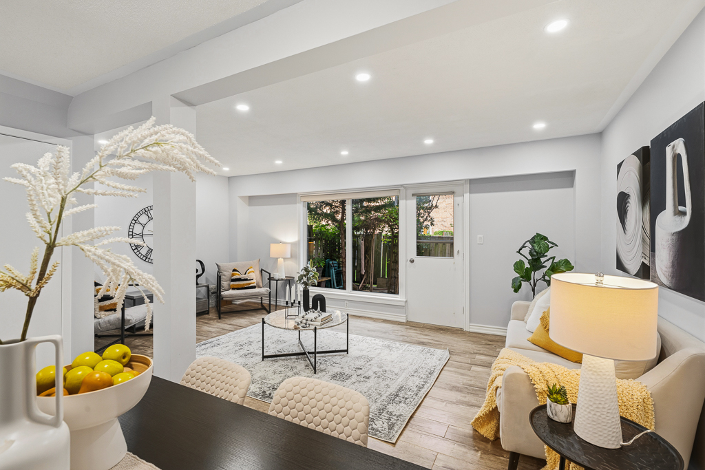 Living room with pot lights and a door out to the fenced backyard