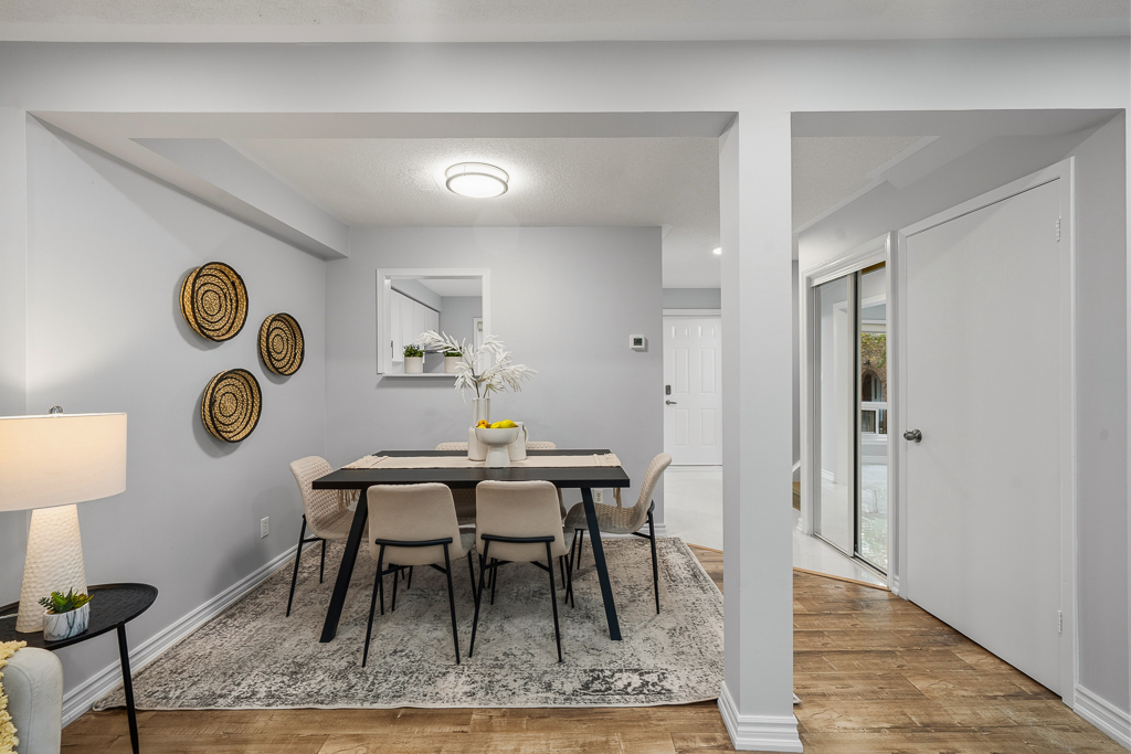 Dining area with woven wall baskets, a round-back table and open view to the entry