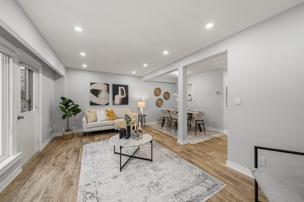 Living area with fresh paint, framed art and a side entry door